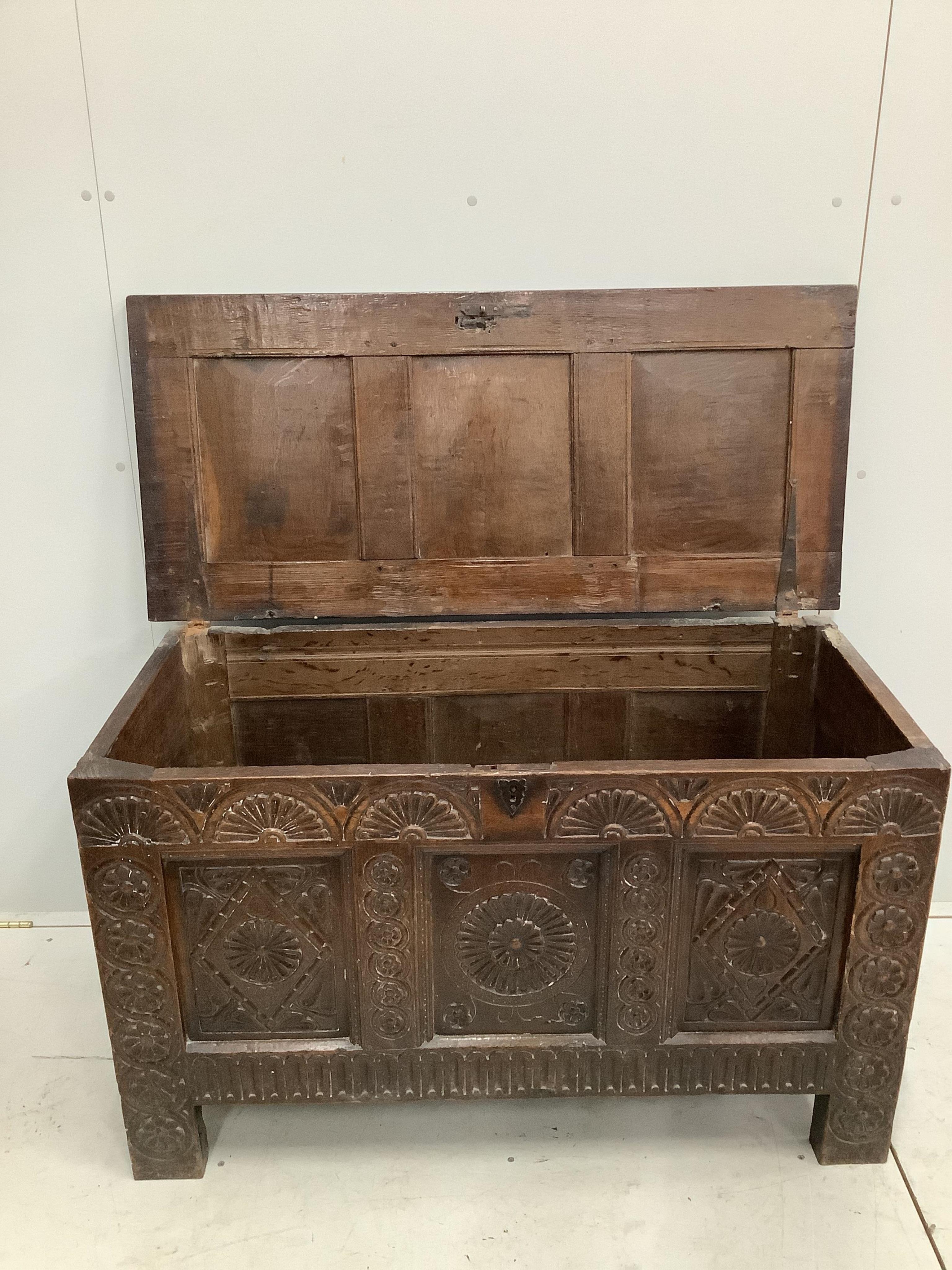 An 18th century carved oak coffer, width 117cm, depth 53cm, height 71cm. Condition - fair